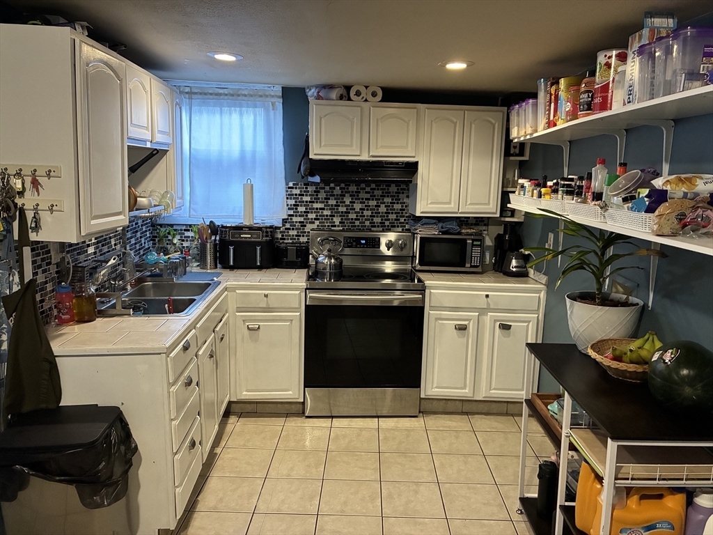 89 Worcester Street Southbridge, MA 01550 - Photo 8 of 18 a kitchen with a sink stove and cabinets