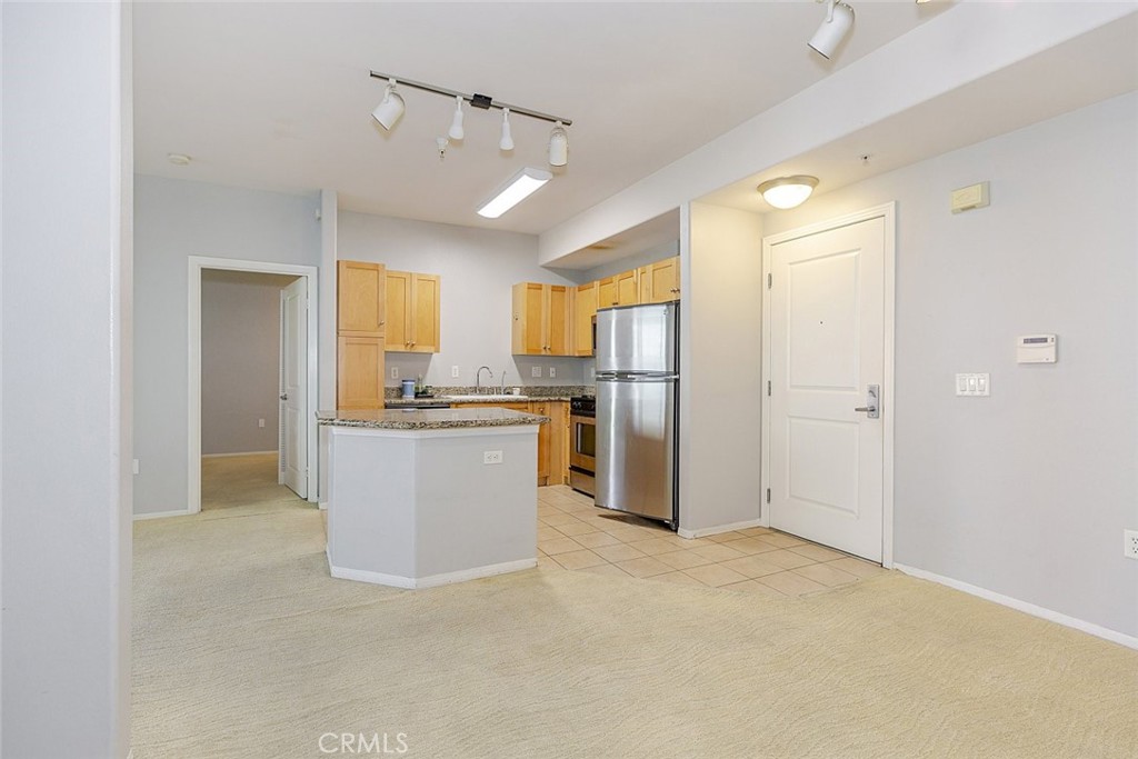 100 South Alameda Street, Unit 353 Los Angeles, CA 90012 - Photo 12 of 60 a view of kitchen with refrigerator cabinets and wooden floor