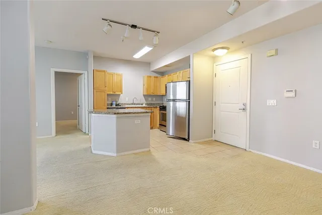 a kitchen with a stove a refrigerator and a sink
