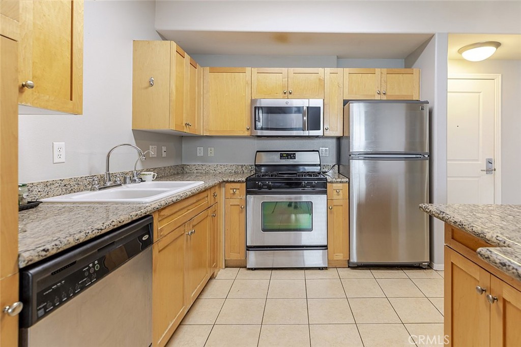 100 South Alameda Street, Unit 353 Los Angeles, CA 90012 - Photo 15 of 60 a kitchen with a sink stove and refrigerator
