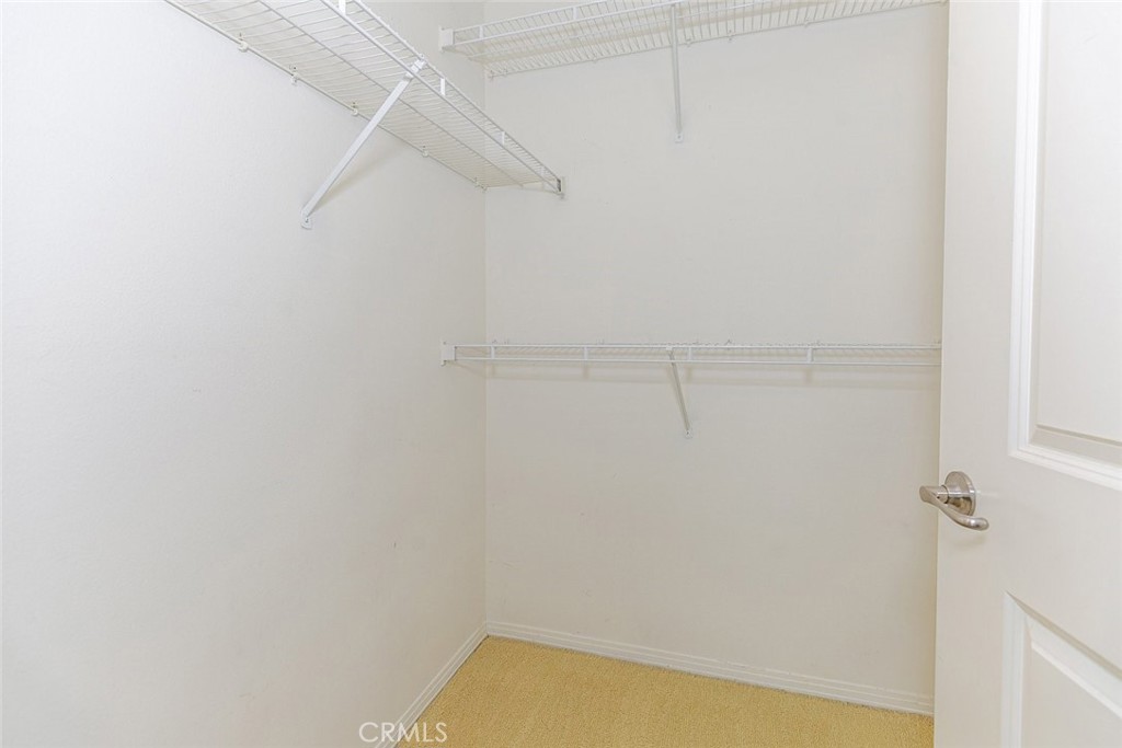 100 South Alameda Street, Unit 353 Los Angeles, CA 90012 - Photo 19 of 60 a view of a room with racks on the wall
