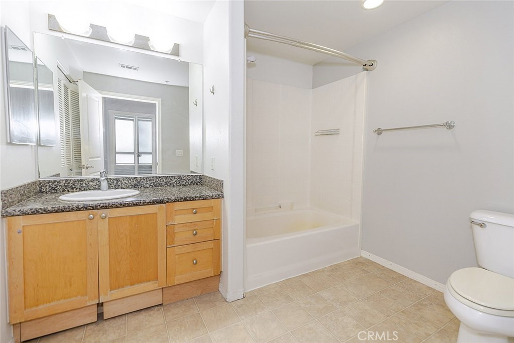 100 South Alameda Street, Unit 353 Los Angeles, CA 90012 - Photo 20 of 60 a bathroom with a granite countertop sink toilet and shower