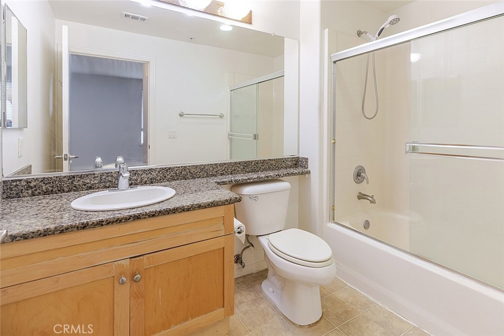 100 South Alameda Street, Unit 353 Los Angeles, CA 90012 - Photo 30 of 60 a bathroom with a granite countertop sink toilet and shower