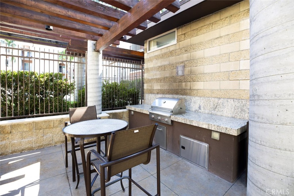 100 South Alameda Street, Unit 353 Los Angeles, CA 90012 - Photo 37 of 60 a kitchen with a table and chairs in it