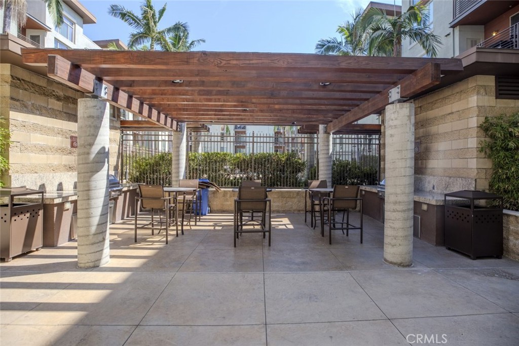 100 South Alameda Street, Unit 353 Los Angeles, CA 90012 - Photo 42 of 60 a view of a patio with a dining table and chairs