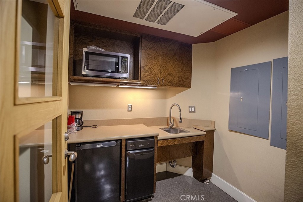 100 South Alameda Street, Unit 353 Los Angeles, CA 90012 - Photo 54 of 60 a kitchen with a sink and a microwave