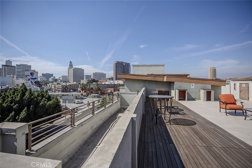 100 South Alameda Street, Unit 353 Los Angeles, CA 90012 - Photo 56 of 60 a view of a rooftop deck with chairs and wooden floor