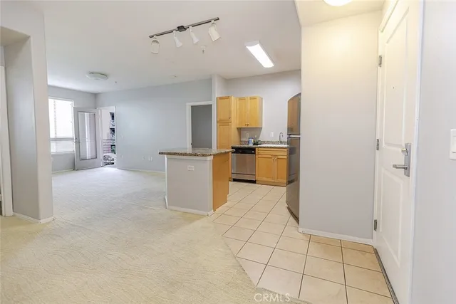 a kitchen with refrigerator and cabinets