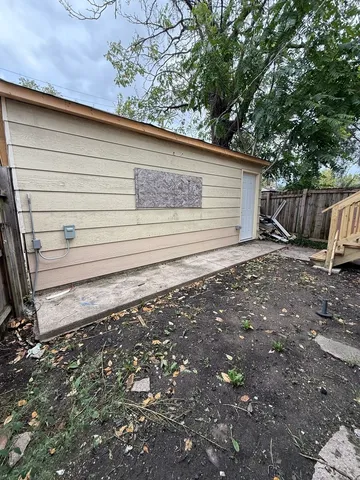 a view of a backyard with pathway and fence