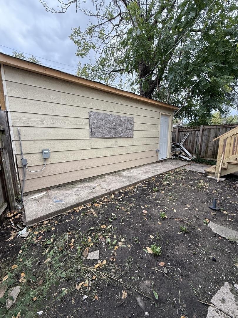 7115 South Peoria Street Chicago, IL 60621 - Photo 15 of 19 a view of a backyard with pathway and fence