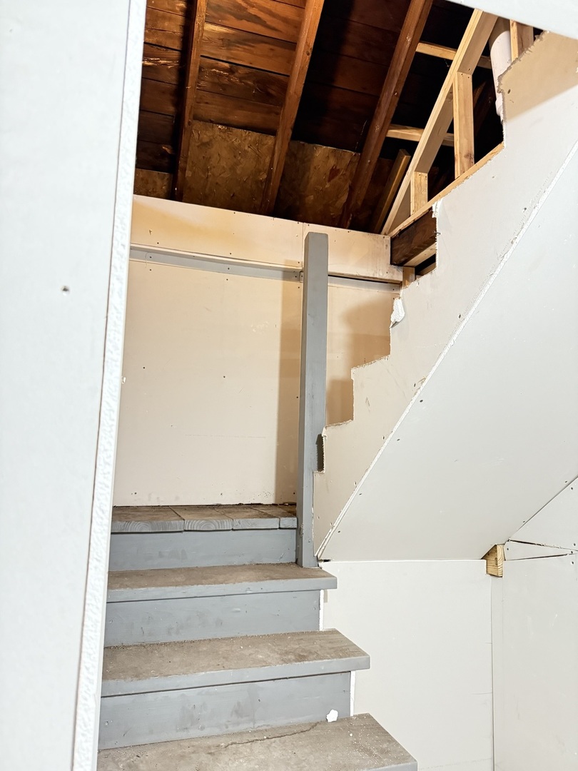 7115 South Peoria Street Chicago, IL 60621 - Photo 8 of 19 a view of staircase with white walls and a window