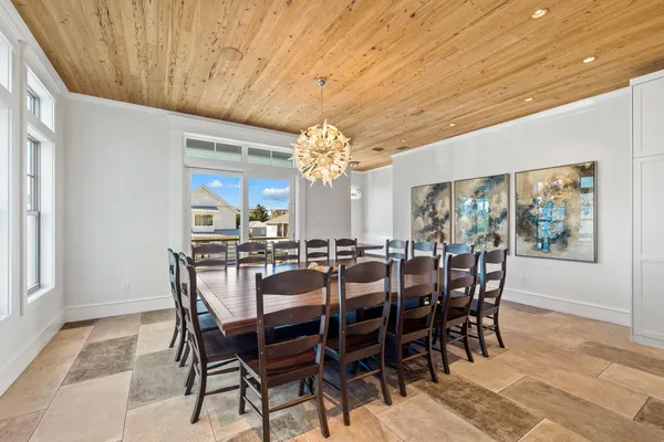 a view of a dining room with furniture and chandelier