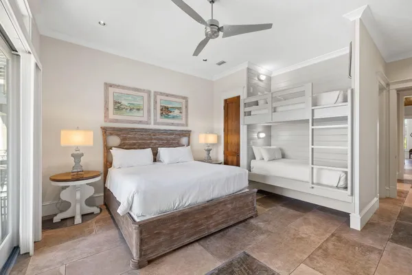 a bedroom with a bed and a lamp on a dresser