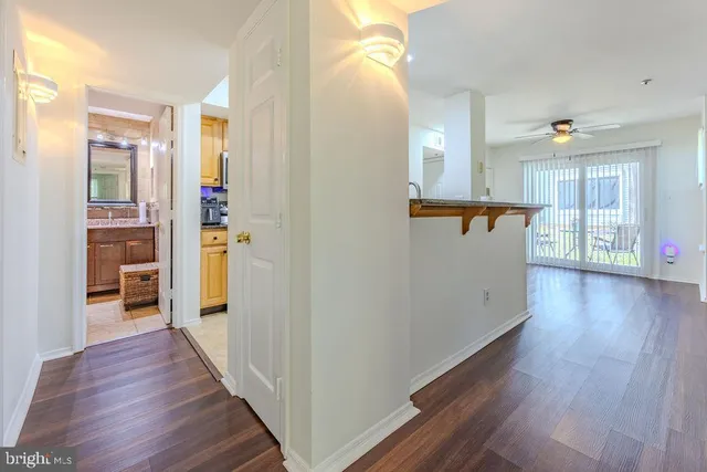 a view of a hallway with wooden floor