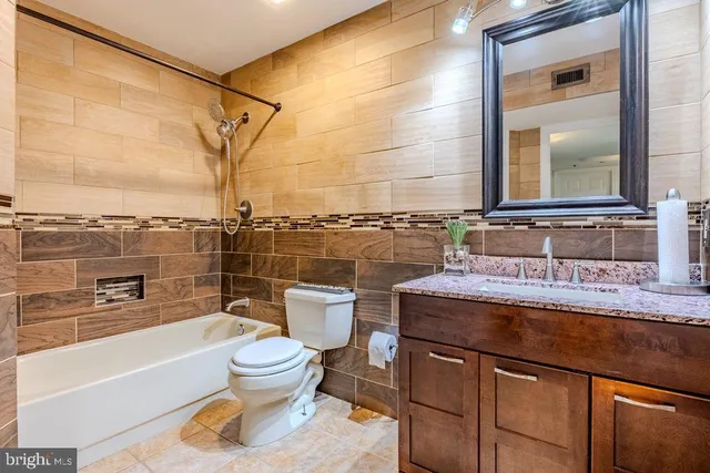 a bathroom with a sink a toilet and a shower