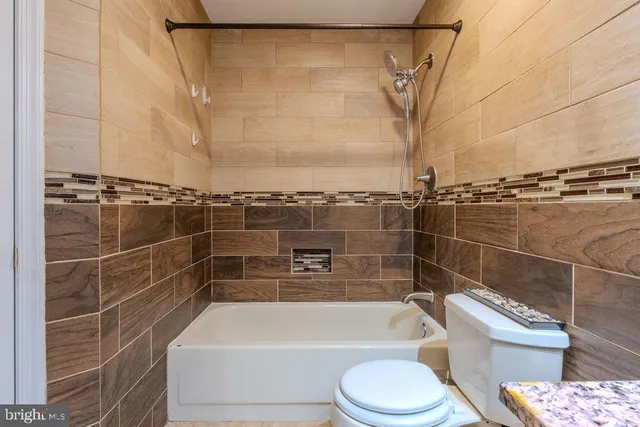 a bathroom with a toilet bathtub and shower
