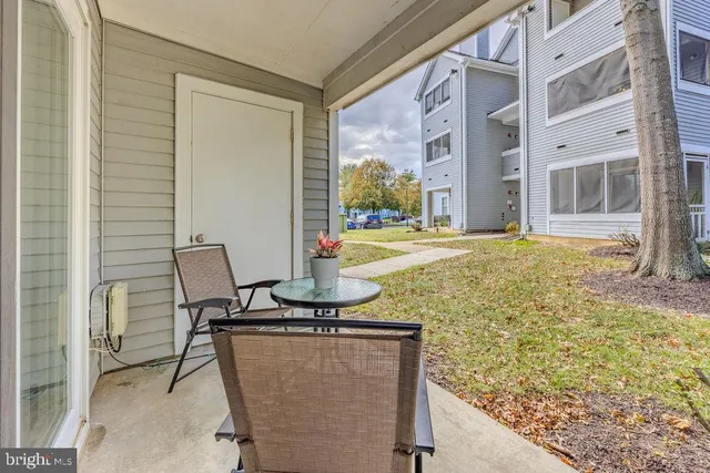 a view of a patio with table and chairs and wooden floor