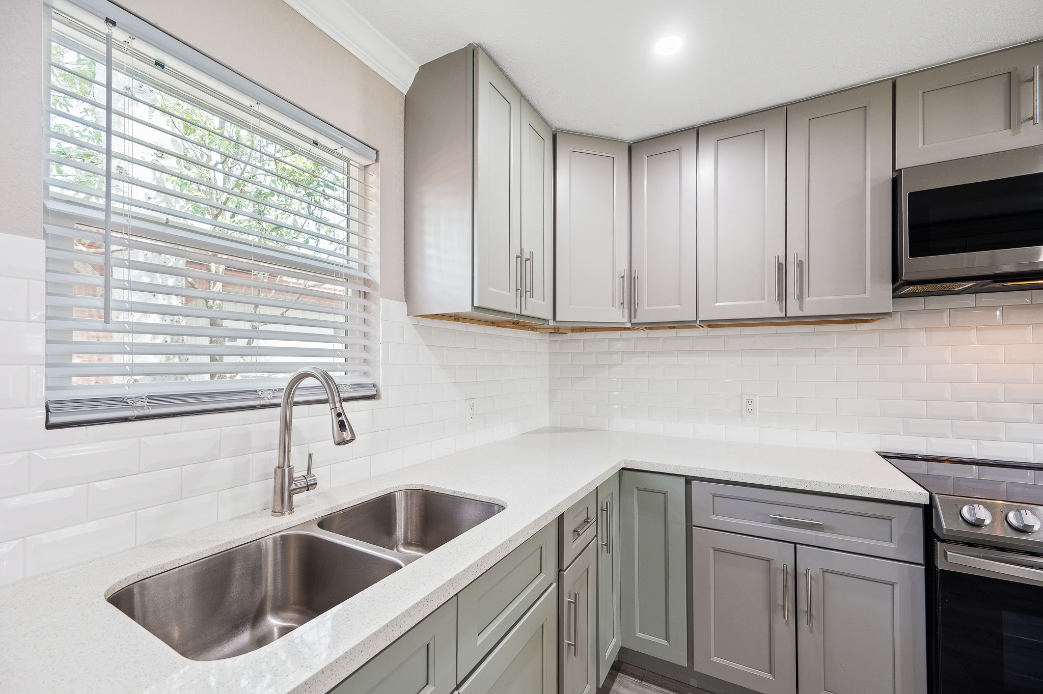 2222 Peppermill Road Houston, TX 77080 - Photo 12 of 38 a kitchen with stainless steel appliances white cabinets sink and window