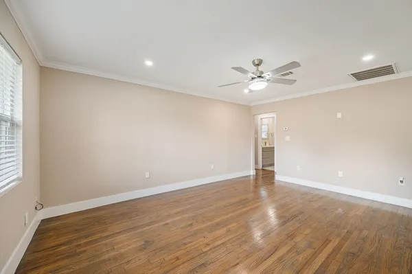 wooden floor in an empty room with a window