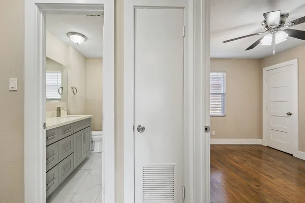 a bathroom with a granite countertop sink mirror and vanity