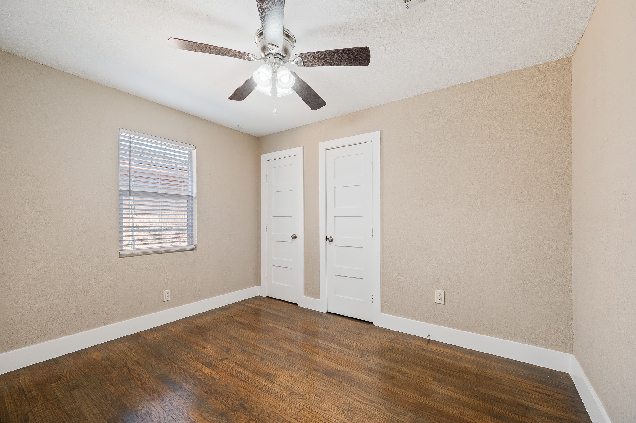 2222 Peppermill Road Houston, TX 77080 - Photo 21 of 38 an empty room with wooden floor chandelier fan and windows