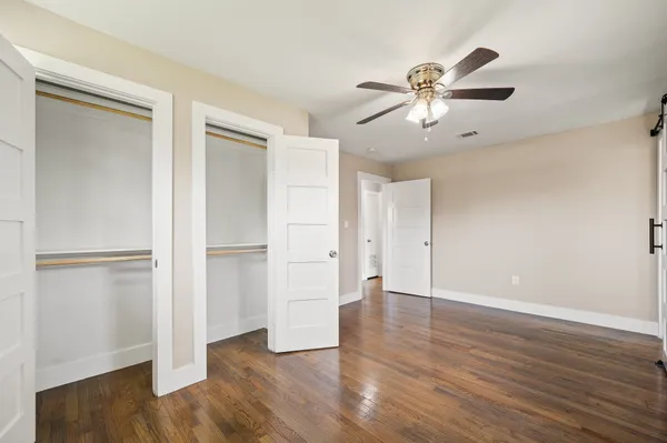a view of an empty room with wooden floor