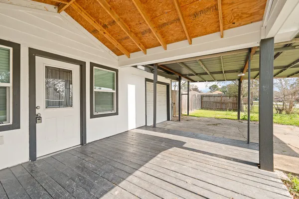 a view of a room with wooden floor and windows