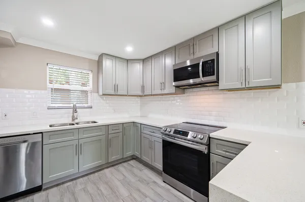 a kitchen with sink cabinets and microwave