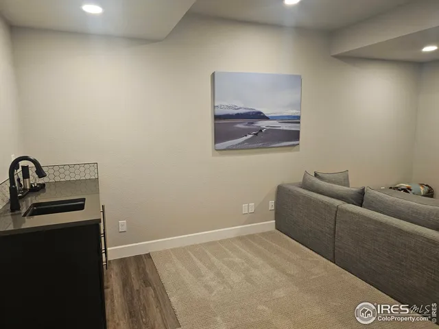 a living room with furniture gym equipment and a window