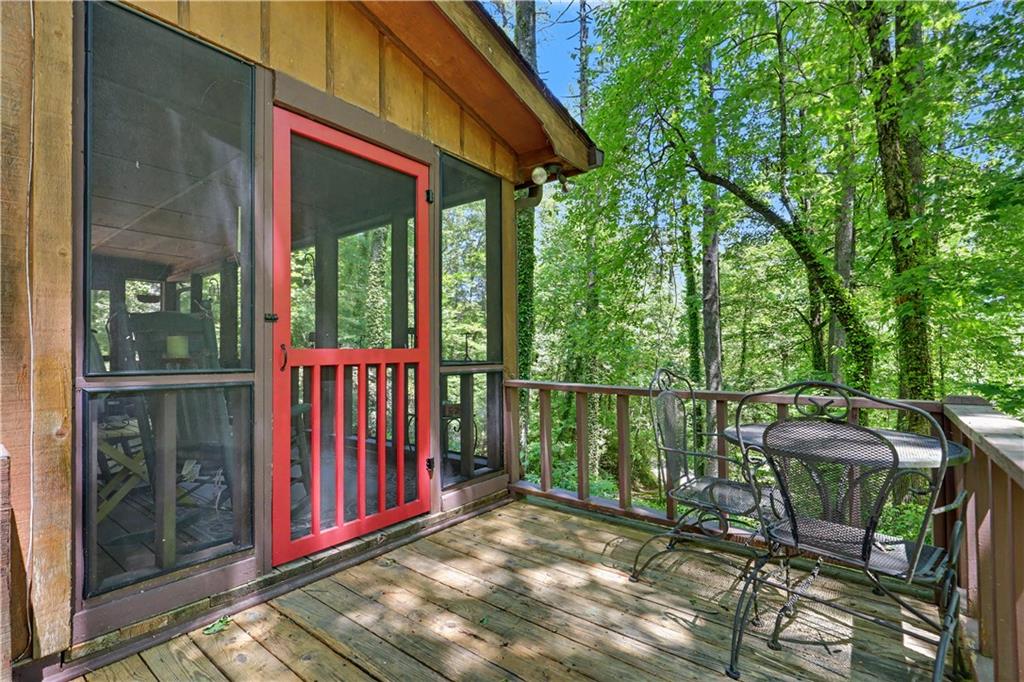 102 Moses Road Rabun Gap, GA 30568 - Photo 31 of 40 a view of a chairs and fire pit in the balcony next to a yard