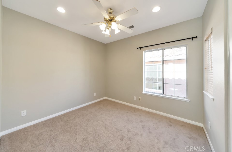 3655 Cll Joaquin Calabasas, CA 91302 - Photo 9 of 15 an empty room with windows and chandelier fan