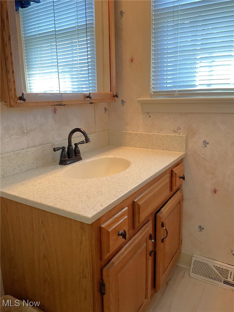 2478 Barrington Road Akron, OH 44333 - Photo 15 of 23 Oak cabinetry and solid surface counter are also featured.
