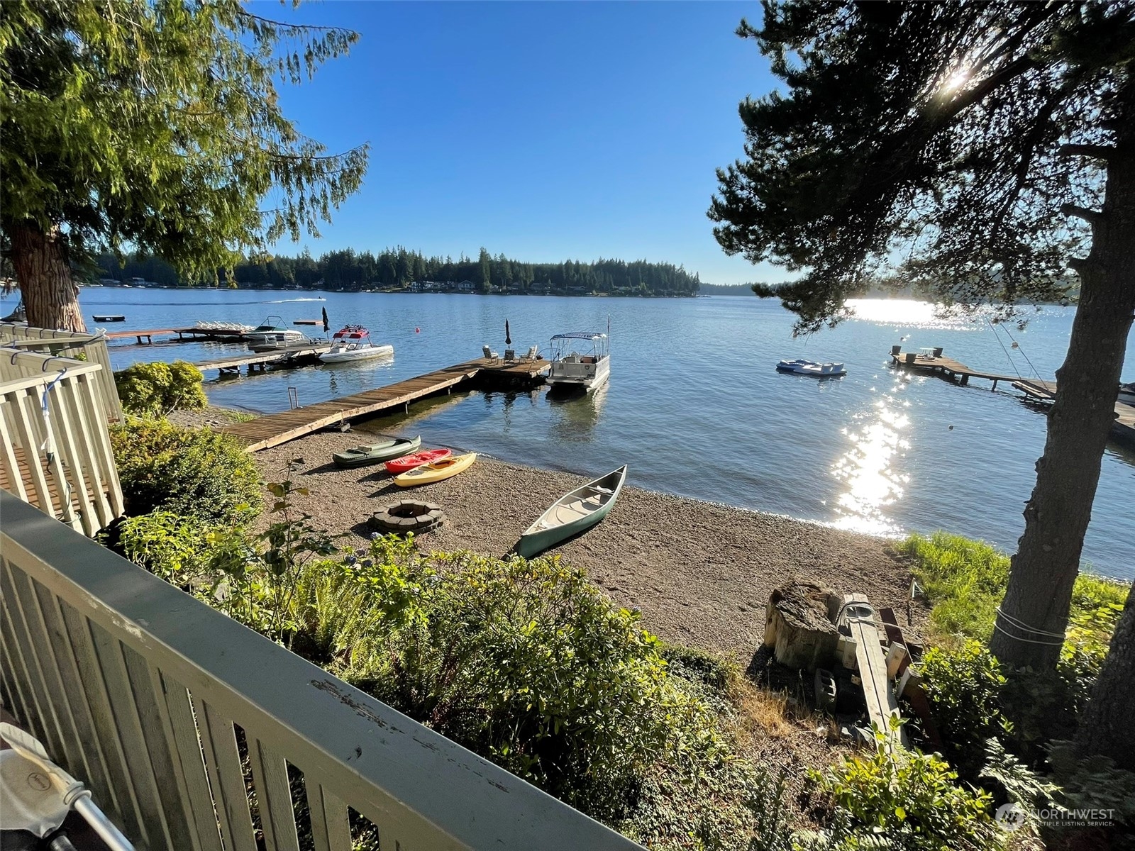 10 Shore Court Grapeview, WA 98546 - Photo 2 of 39 a view of a lake with a floor to ceiling window and wooden fence