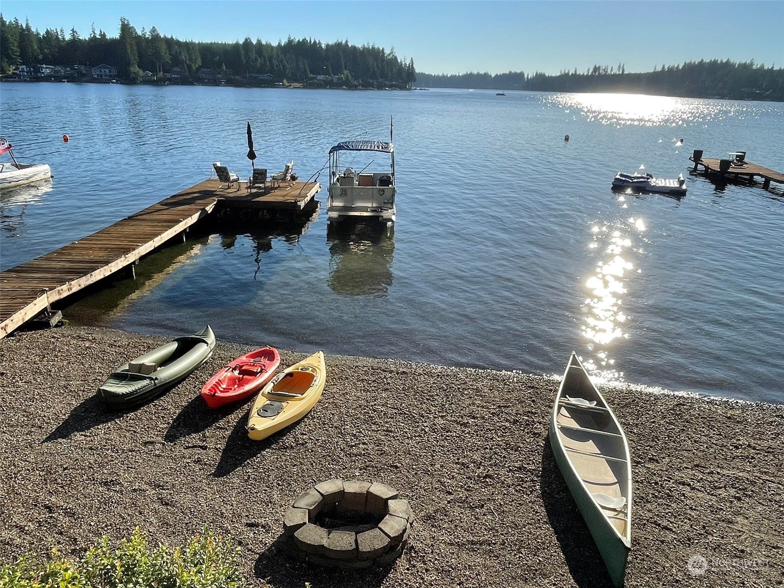 10 Shore Court Grapeview, WA 98546 - Photo 3 of 39 a view of a lake with outdoor seating