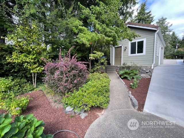 10 Shore Court Grapeview, WA 98546 - Photo 37 of 39 a front view of a house with a yard and outdoor seating