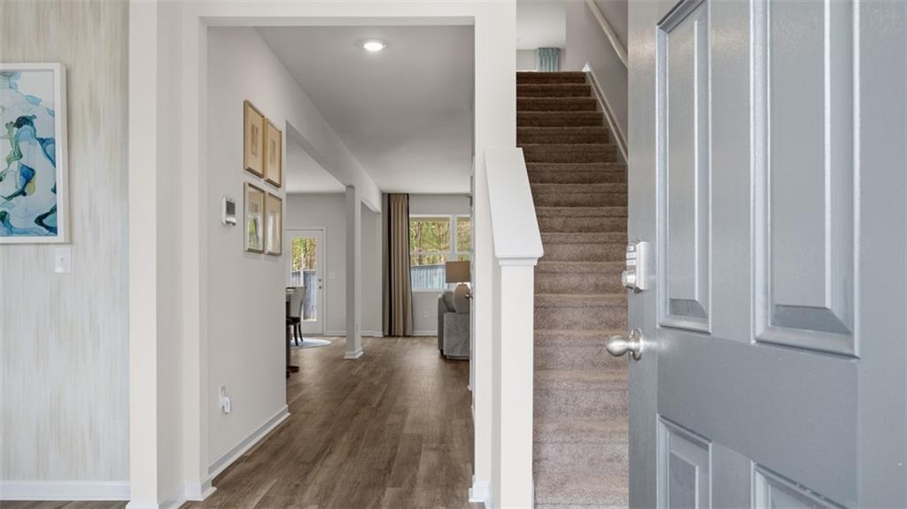 460 Bullock Pass Jefferson, GA 30549 - Photo 2 of 60 a view of a hallway with wooden floor and staircase