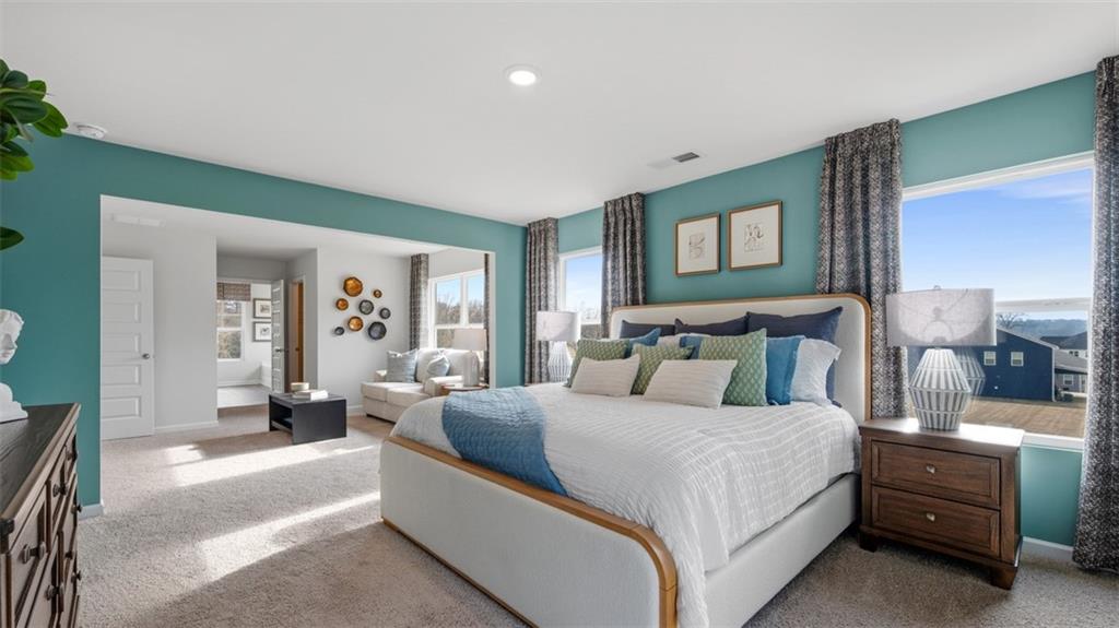 460 Bullock Pass Jefferson, GA 30549 - Photo 27 of 60 a bedroom with a large bed and paintings on the wall