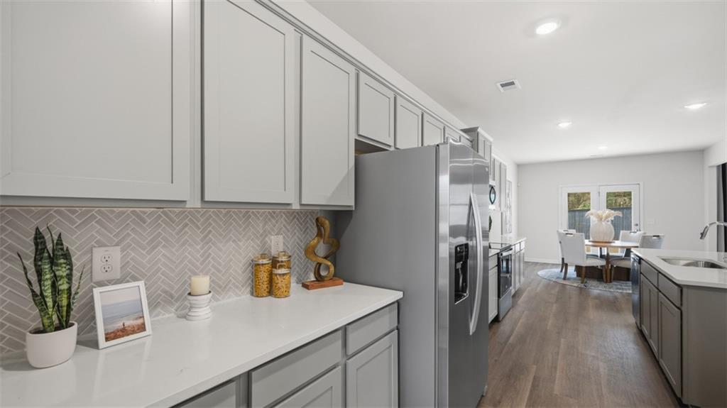 460 Bullock Pass Jefferson, GA 30549 - Photo 10 of 60 a kitchen with stainless steel appliances a refrigerator a sink a stove and white cabinets