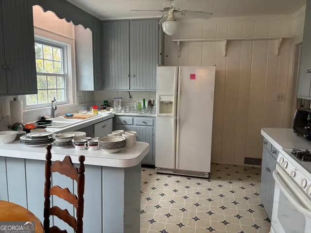 a kitchen with a sink a refrigerator and a stove