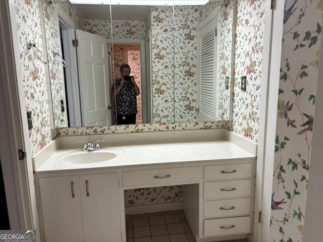a bathroom with a sink and a mirror