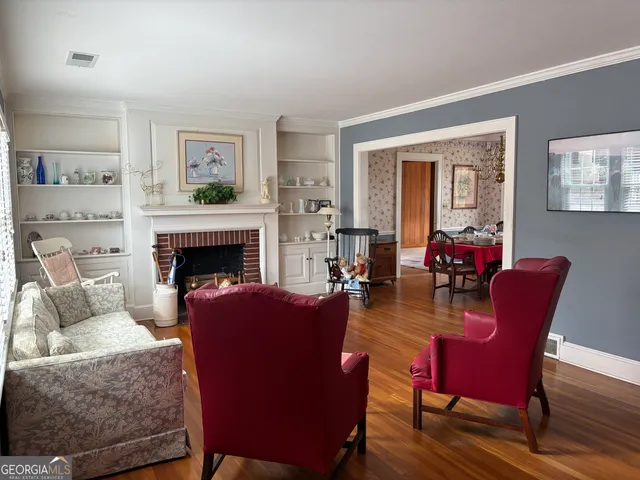 a living room with furniture a large window and a fireplace