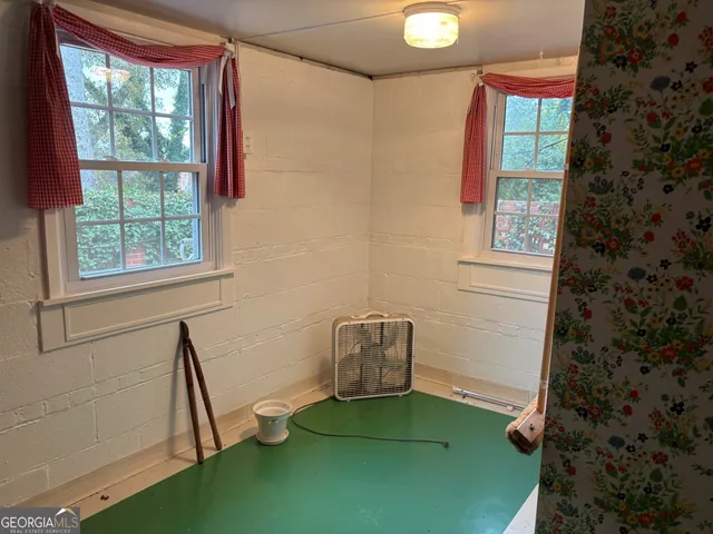a bathroom with a sink toilet and window