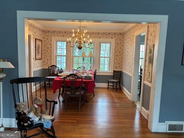a view of a dining room with furniture window and wooden floor