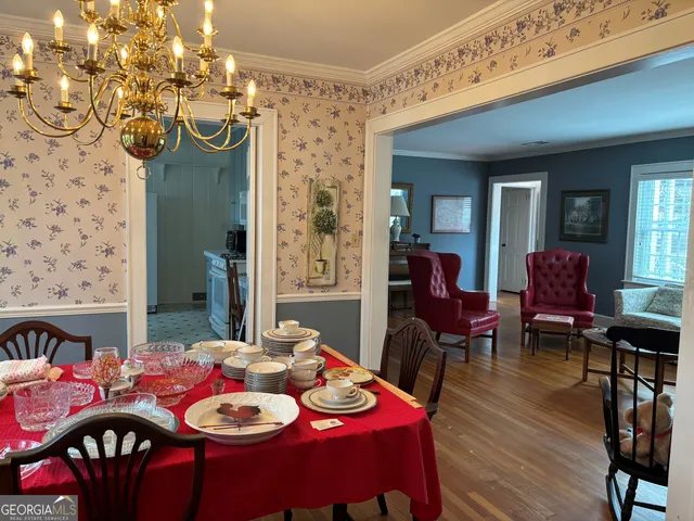 a view of a dining room with furniture and wooden floor