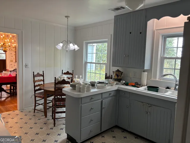 a kitchen with a sink stove and cabinets