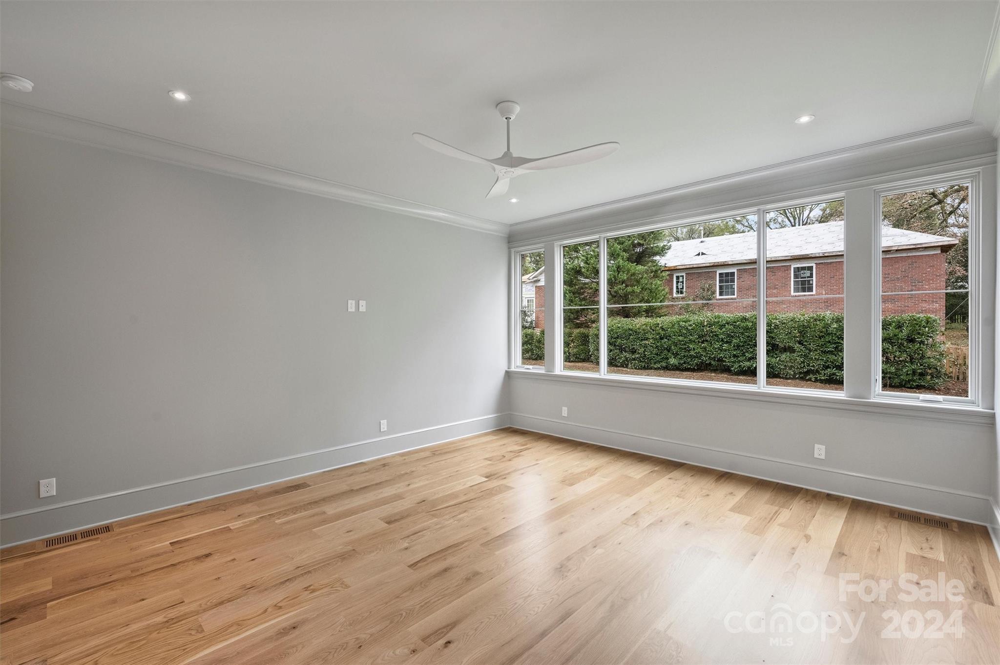 1601 Coventry Road Charlotte, NC 28211 - Photo 20 of 40 a view of an empty room with wooden floor and a window