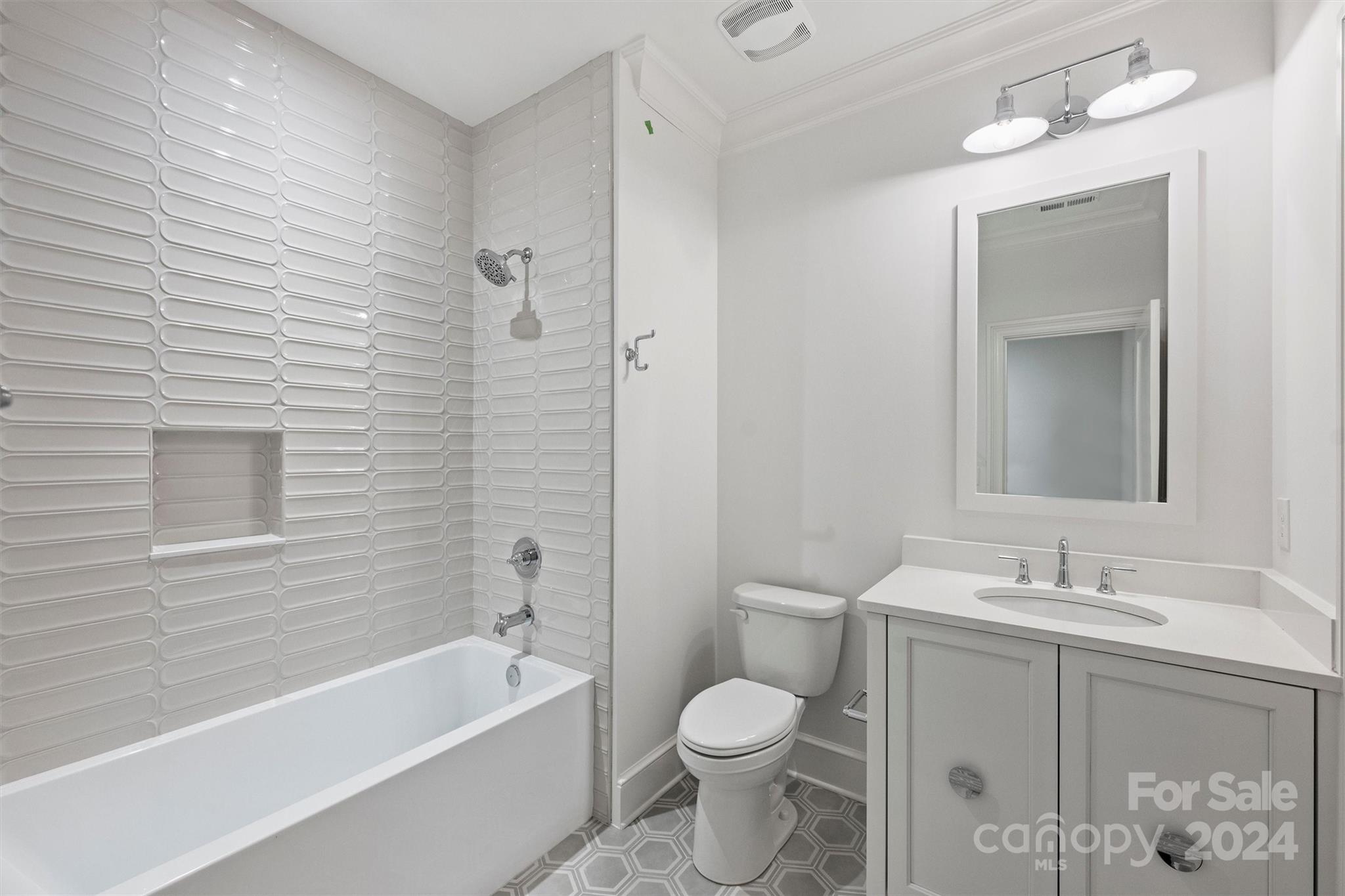 1601 Coventry Road Charlotte, NC 28211 - Photo 33 of 40 a bathroom with a bathtub shower sink vanity mirror and toilet