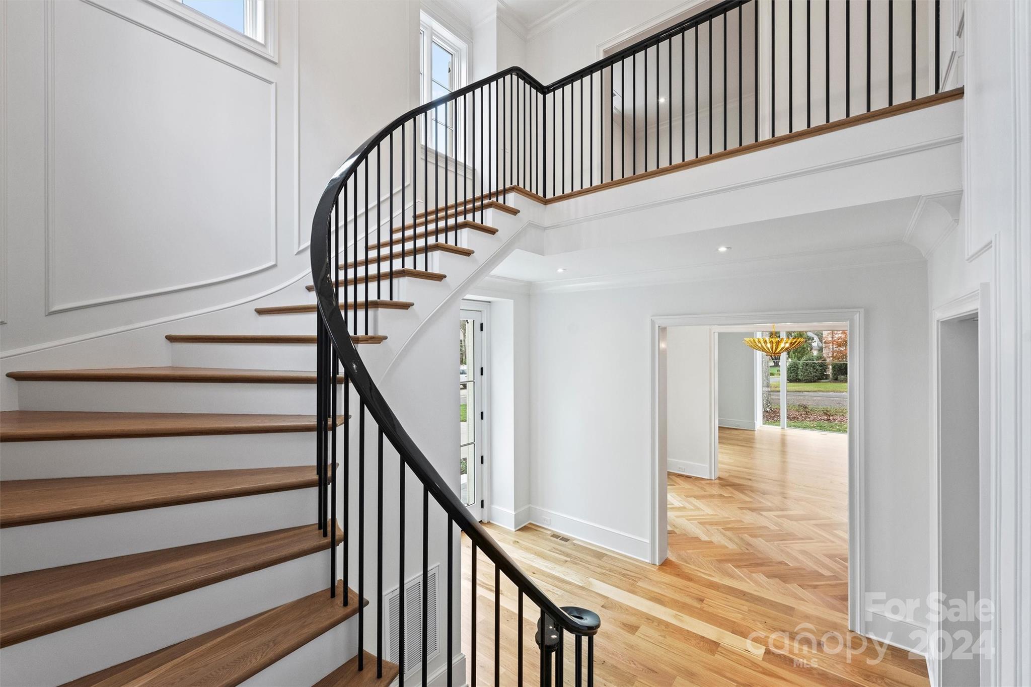 1601 Coventry Road Charlotte, NC 28211 - Photo 4 of 40 a view of staircase with wooden floor and white walls