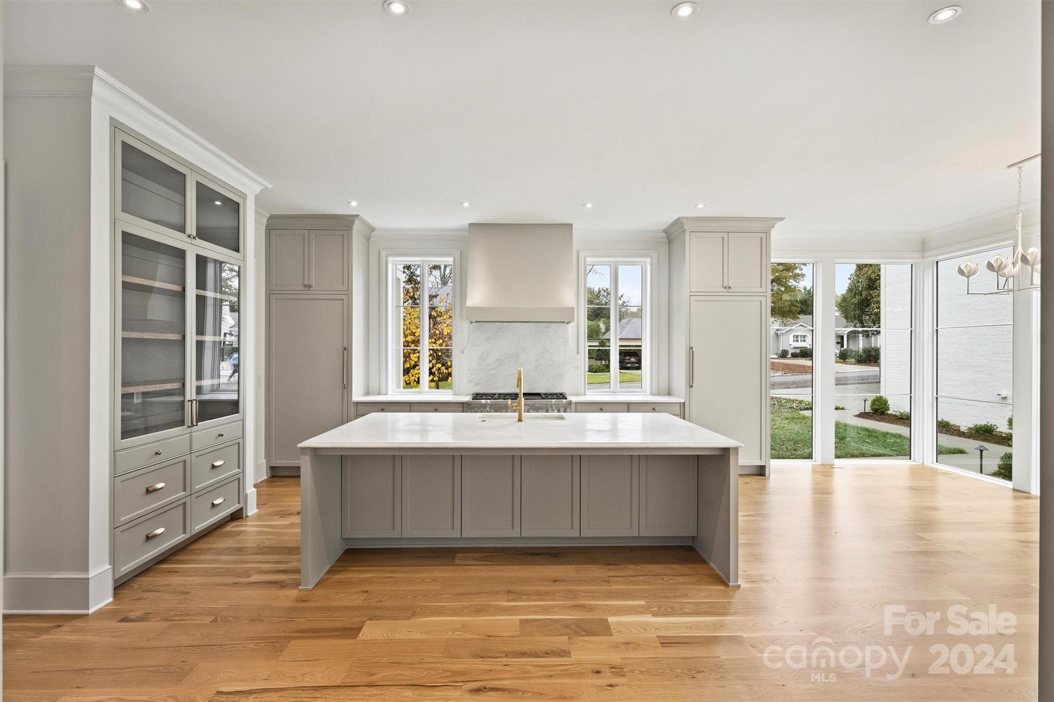 1601 Coventry Road Charlotte, NC 28211 - Photo 10 of 40 a view of kitchen island with stainless steel appliances kitchen island wooden floor and living room