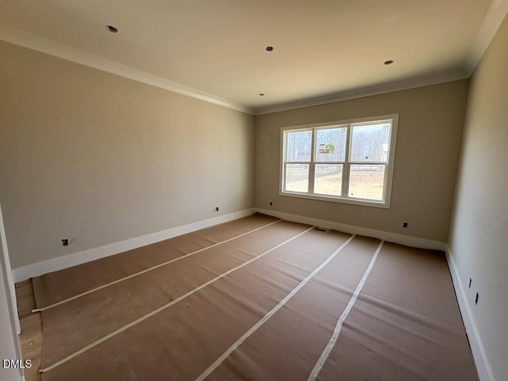 5864 Carriage Gate Drive Raleigh, NC 27603 - Photo 10 of 37 a view of an empty room with a window